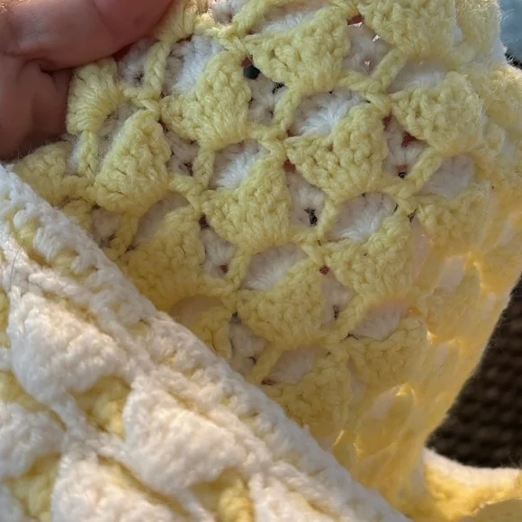 Crocheted yellow and white baby blanket throw